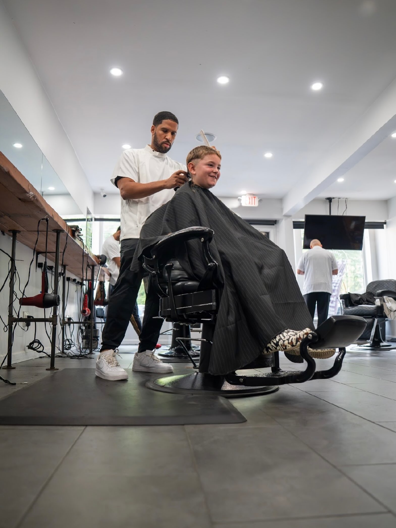 Modern fade and textured hairstyle at Create Barbershop